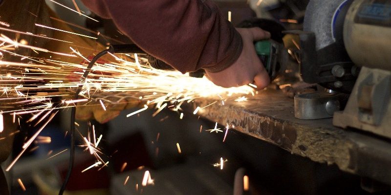 A person cutting metal with a chainsaw